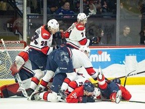 Regina Pats captain Connor Bedard  (98) was at a bottom of a pile of players in front of the Lethbridge Hurricanes net on Monday at the Brandt Centre.