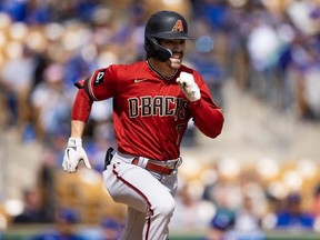 Diamondbacks outfielder Corbin Carroll runs to first base against the Dodgers during a spring training game at Camelback Ranch-Glendale, in Phoenix, March 2, 2023.