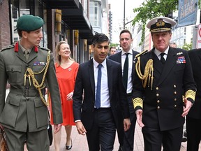 British Prime Minister Rishi Sunak, centre, is accompanied by a delegation of British military members in San Diego, California ahead of talks with U.S. President Joe Biden and Australian Prime Minister Anthony Albanese to discuss the procurement of nuclear-powered submarines under a pact between the three nations, March 12, 2023.