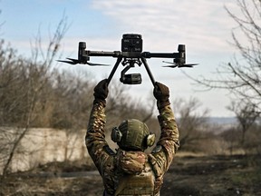 A Ukrainian soldier flies a drone to spot Russian positions near the city of Bakhmut, in the Donbas region, on March 5, 2023.