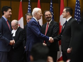 U.S. President Joe Biden shakes hands with Conservative Party of Canada Leader Pierre Poilievre, as Prime Minister Justin Trudeau looks on, during a welcoming ceremony on Parliament Hill in Ottawa, on Friday, March 24, 2023.