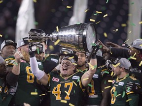 Edmonton's JC Sherritt hoists the Grey Cup after his teams win over the Ottawa Redblacks during the 103rd Grey Cup in Winnipeg on Sunday, Nov. 29, 2015.
