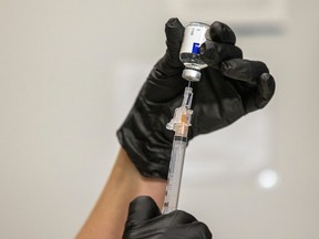 A pharmacist at Sherwood Co-op Pharmacy gets a seasonal flu shot ready as part of this year's influenza immunization campaign on Thursday, October 14, 2021 in Regina.