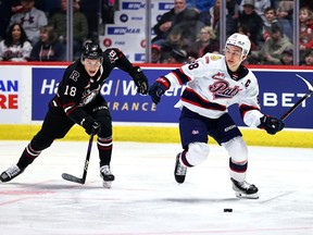 The Regina Pats' Connor Bedard and Red Deer Rebels' Jace Isley chase the puck during a Saturday Western Hockey League game in Regina. (Keith Hershmiller Photography)