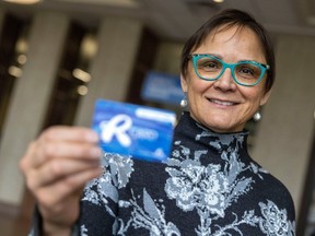Ward 1 Councillor Cheryl Stadnichuk holds up her R card at City Hall on Friday, March 10, 2023 in Regina.