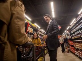 Prime Minister Justin Trudeau meets Willow Iorga (L) and her daughter Aurora Iorga during a planned media event at the Harbour Landing Co-op during during a visit to the province while announcing a federal grocery rebate that is connected with the Budget 2023 on Thursday, April 13, 2023 in Regina.