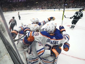 Edmonton Oilers players celebrate with left wing Evander Kane (91) after he scored during the third period of Game 4 of an NHL hockey Stanley Cup first-round playoff series hockey game against the Los Angeles Kings Sunday, April 23, 2023, in Los Angeles.