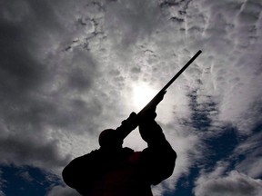 A hunter checks the sight of his rifle at a hunt camp west of Ottawa.