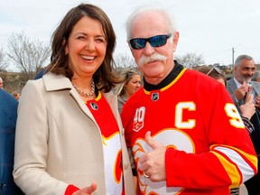 Alberta Premier Danielle Smith, left, poses for a photo with Calgary Flames great Lanny McDonald during an announcement of a new arena in Calgary, on April 25.