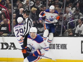 Edmonton Oilers left wing Zach Hyman (18) celebrates with center Leon Draisaitl (29) and defenseman Evan Bouchard (2) after scoring during overtime of Game 4 of an NHL hockey Stanley Cup first-round playoff series hockey game against the Los Angeles Kings Sunday, April 23, 2023, in Los Angeles. The Oilers won 5-4.
