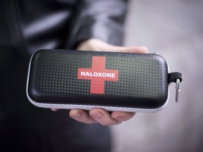 A naloxone anti-overdose kit is held in downtown Vancouver, B.C., Friday, Feb. 10, 2017. British Columbia Emergency Health Services has released grim statistics on the toxic drug crisis ahead of the seventh anniversary of the province declaring a public health emergency.