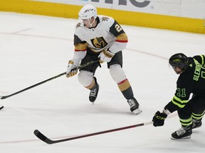 Vegas Golden Knights defenceman Zach Whitecloud (2) skates with the puck as Dallas Stars center Luke Glendening (11) moves in during the first period of an NHL hockey game in Dallas, Saturday, April 8, 2023. Members from Sioux Valley Dakota Nation in southwestern Manitoba donned Vegas Golden Knights jerseys as they watched the team battle the Winnipeg Jets during the series-opener Tuesday evening with all eyes on Whitecloud.