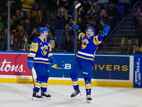 Egor Sidorov (right) and Charlie Wright celebrate a goal for the Saskatoon Blades against the Regina Pats during first-round playoff action.