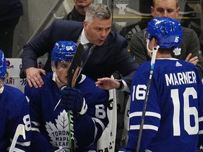Toronto Maple Leafs head coach Sheldon Keefe congratulates forward Mitchell Marner (16) and forward David Kampf (64) after his goal against the Tampa Bay Lightning during the second period of Game 1 of the first round of the 2022 Stanley Cup Playoffs at Scotiabank Arena.