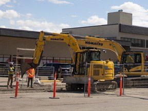 Construction crews work on an underground pipe on Broad street on Wednesday, April 26, 2023 in Regina. From April 12th Broad street from Victoria avenue to Saskatchewan drive will be restricted for nine weeks while crews reline an underground pipe.