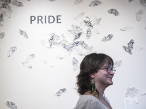 Alexis Valgardsson stands in front of their piece titled Metamorphosis during the reception for the Pride exhibit at the Moose Jaw Museum and Art Gallery on Wednesday, May 31, 2023 in Moose Jaw.