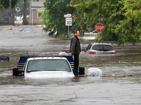 Man and vehicle on flooded street