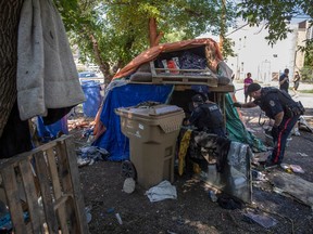 Regina Police Service officers and members of Regina Fire And Protective Services were the scene Wednesday morning as a homeless encampment was torn down.