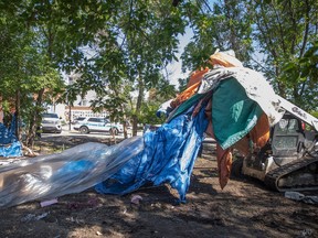 Regina Police Service officers and members of Regina Fire And Protective Services were the scene Wednesday morning as a homeless encampment was torn down.