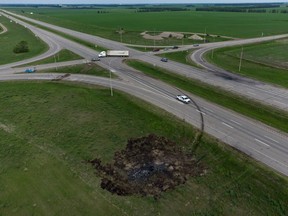 A scorched patch of ground where a bus carrying seniors ended up after colliding with a transport truck and burning on Thursday is seen on the edge of the Trans-Canada Highway where it intersects with Hwy 5, west of Winnipeg near Carberry, Man., Friday, June 16, 2023. Police said 15 people were killed and 10 more were sent to hospital.