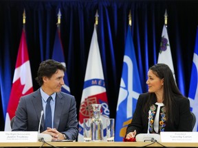 Prime Minister Justin Trudeau and Metis National Council President Cassidy Caron, middle, co-chair a Metis National Council meeting in Ottawa on Thursday, June 1, 2023.