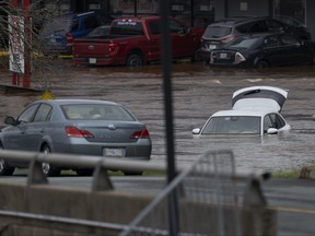 Abandoned cars in a mall parking lot are seen in floodwater following a major rain event in Halifax on Saturday, July 22, 2023.