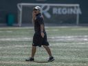 Saskatchewan Roughriders head coach Craig Dickenson walks on field during practice at Mosaic Stadium.