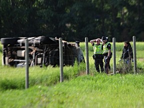 Edmonton police investigate the scene of an early morning collision in the area of 17 Street and 34 Avenue where a 2014 Cadillac Escalade rolled into a nearby field and engulfed in flames on Saturday, July 29, 2023.