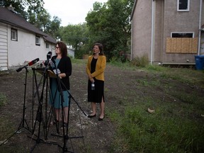 REGINA, SASK : July 25, 2023--Saskatchewan NDP Leader Carla Beck speaks at a podium beside NDP housing critic Meara Conway in front of a Saskatchewan Housing Corporation unit on Rae street to discuss the current housing issue on Tuesday, July 25, 2023 in Regina. KAYLE NEIS / Regina Leader-Post