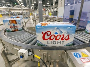 Cases of Coors light roll along the production line at the Molson Coors Longueil brewery in St-Hubert, south of Montreal Tuesday October 11, 2022.