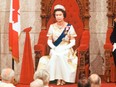 Queen Elizabeth II officially opens the session of Parliament in the Senate chamber in Ottawa on October 18, 1977.