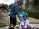 Clifton Lonechild and his partner Dezary Littletent wait for social services to find a temporary housing solution as camp members are told that they need to be vacated from City Hall in the next 24 hours as a push to dismantle the pop-up encampment thats has held around eighty five tents on Thursday, July 27, 2023 in Regina. Both Lonechild and Littletent opted out of staying at the shelter offered as they didn't feel safe and where concerned about being separated.