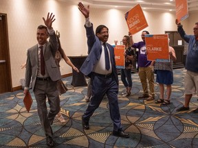 Newly elected MLAs Jared Clarke (left) and Noor Burki walk into a conference hall after winning their seats in the 2023 provincial byelection at the DoubleTree Hotel on Thursday, August 10, 2023 in Regina. KAYLE NEIS / Regina Leader-Post