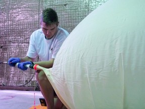 University of Saskatchewan masters of science in physics student Remington Rohel inflates the stratospheric balloons for launch in Cudworth, which is located about 90 kilometres northeast of Saskatoon, on July 25 as part of the International Space Mission Training Program.