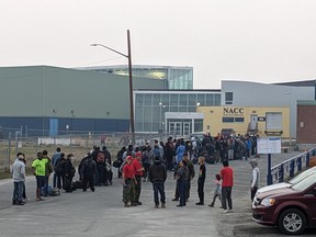 People without vehicles line up to register for a flight to Calgary in Yellowknife on Thursday, Aug. 17, 2023.