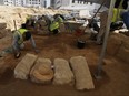 Palestinian archaeologists remove sand from graves at the Roman cemetery in Jebaliya northern Gaza Strip, Saturday, Sept. 23, 2023. The ancient cemetery was uncovered last year during construction of a housing project. Researchers have uncovered 135 graves, including two sarcophagi made of lead.