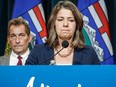 Alberta Premier Danielle Smith, right, becomes emotional as she speaks to the media about an E-coli outbreak at several Calgary daycares as Dr. Mark Joffe, Alberta chief medical officer of health, looks on in Calgary, Alta., Friday, Sept. 15, 2023.