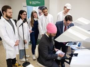 Second-year dental students watch federal NDP Leader Jagmeet Singh try out one of their teaching simulations at the Dental Education Clinic at the University of Saskatchewan. Photo taken in Saskatoon, Sask. on Thursday, April 13, 2023.