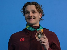 Canada's Blake Tierney poses with the bronze medal during the podium ceremony of the men's 100m backstroke final A swimming event of the Pan American Games Santiago 2023, at the Aquatics Centre in the National Stadium Sports Park in Santiago, on October 23, 2023. (Photo by MAURO PIMENTEL / AFP)