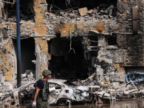A member of the security forces walks past an Israeli police station in Sderot after it was damaged during battles to dislodge Hamas militants who were stationed inside, on Oct. 8, 2023.