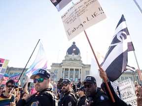 Attendees at a rally against the policy concerning pronouns in school, a policy which was the subject of a court case and injunction mere weeks ago, are separated by Regina Police Services from supporters of the policy on Tuesday, October 10, 2023 in Regina. KAYLE NEIS / Regina Leader-Post