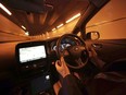 Nissan Motor Co. General Manager Tetsuya Iijima gets his hands off of the steering wheel of a self-driving prototype vehicle during a test drive in Tokyo, Tuesday, Nov. 3, 2015.