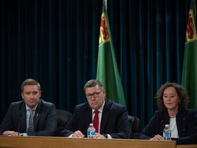 Minister of Education Jeremy Cockrill, Premier Scott Moe and Ministry of Justice and Attorney General Bronwyn Eyre answer questions at a press conference after passing Bill 137 at the Saskatchewan Legislative building on Friday, October 20, 2023 in Regina.