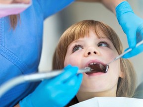 A child receives dental care from a dentist in this file photo.