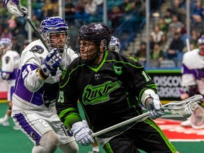 Saskatchewan Rush forward Ryan Keenan (15) runs with the ball as Panther City Lacrosse Club defenceman Liam Byrnes (21) defends during the third quarter of National Lacrosse League action at Sasktel Centre in Saskatoon, Sask., on Saturday, December 31, 2022.