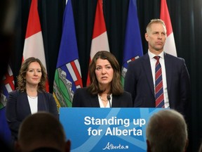 Alberta Premier Danielle Smith, with Minister of Environment and Protected Areas Rebecca Schulz and Minister of Affordability and Utilities Nathan Neudorf, at a news conference where they outlined the Alberta sovereignty act motion that will be brought before the Alberta Legislature, in Edmonton, Monday Nov. 27, 2023.