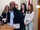 CUPE Local 5430 president Bashir Jalloh stands with a group of Regina medical technologists for a press conference on staffing shortages at Pasqua Hospital at the legislature on Nov. 29, 2023.
