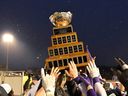 Western University Mustangs players carry the trophy after winning over the Saskatchewan Huskies, at the Vanier Cup in Quebec City Saturday, Dec. 4, 2021.