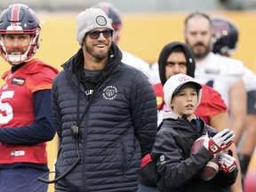 The sideline outbursts that were common during Montreal Alouettes head coach Jason Maas' tenure as the Edmonton Elks head coach (2016-19) have been non-existent this season with the Alouettes. Maas, centre, laughs next to his son Bear, right, during practice ahead of the 110th CFL Grey Cup against the Winnipeg Blue Bombers in Hamilton, Ont., Friday, Nov. 17, 2023.