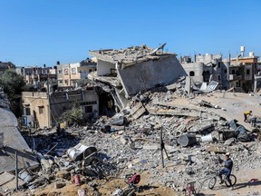 Palestinian citizens inspect the effects of destruction caused by air strikes on their homes on November 29, 2023 in Khan Yunis, Gaza.